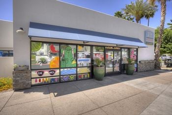 The outside of a store with a window display of fruit and vegetables